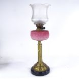 A brass and pink opalescent glass oil lamp, with etched glass shade, overall height including