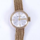 GARRARD - a lady's Vintage 9ct gold mechanical wristwatch, silvered dial with quarterly gilt baton