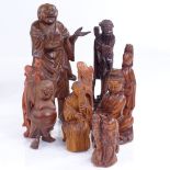 A group of Oriental carved wood standing figures, largest height 17cm