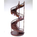 A large mahogany spiral staircase design display stand, with spindled balustrade, late 20th century,
