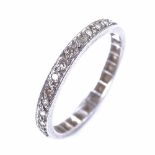 An early 20th century unmarked white metal diamond eternity ring, total diamond content approx 0.
