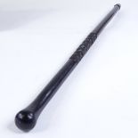 An ebony baton stick with spiral carved design, possibly military, length 61cm