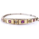 A Victorian unmarked gold 7-stone ruby and diamond hinged bangle, with foliate engraved bridge and