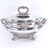 A large silver plated 2-handled soup tureen and cover, with cast foliate decoration on scrolled