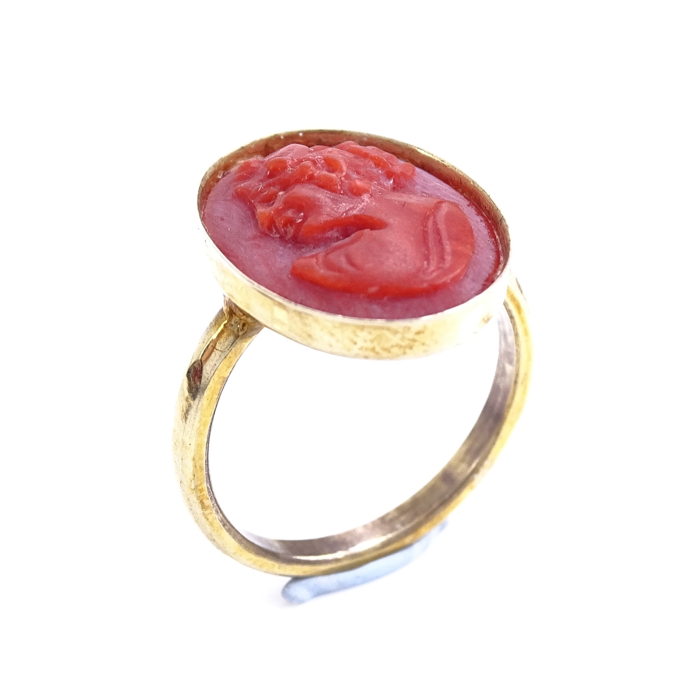 An unmarked silver-gilt relief carved coral cameo ring, setting height 16.7mm, size J, 2.5g Good - Image 2 of 5