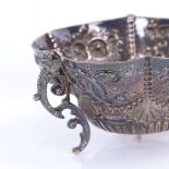 A Victorian Scottish silver sugar bowl, circular lobed form with relief embossed decoration on 3