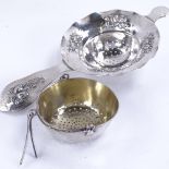 A Swedish swing-handled silver tea strainer, dated 1886, and another Swedish decorative tea