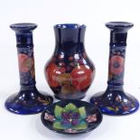 MOORCROFT POTTERY - pair of pomegranate design candlesticks, height 18cm, a vase, height 17cm, and a