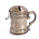 A German unmarked white metal tankard moneybox, with hinged lockable lid and bright-cut engraved