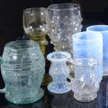 A group of decorative glassware, including a pair of vaseline glass goblets with trailed