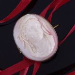 A 19th century relief carved pink coral cameo panel brooch, depicting Classical female bust, in