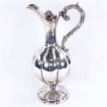 A William IV silver baluster Claret/hot water jug, lobed form with allover foliate engraved