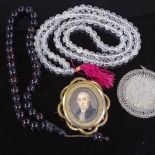 A rock crystal bead necklace, a Victorian gilt-metal brooch with inset painted portrait, a coin