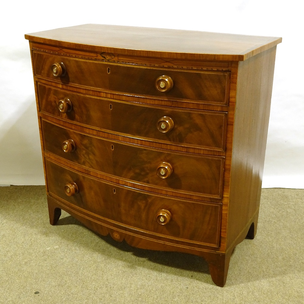 A Regency mahogany and rosewood crossbanded bow-front chest of 4 long drawers, with mother-of-