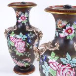 A pair of 19th century porcelain vases and covers, with enamel decoration and gilded ram's head