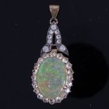 An early 20th century unmarked gold cabochon fire opal and white sapphire pendant, opal length 17.