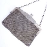 An early 20th century French silver mesh evening purse, floral engraved frame with chainmail link