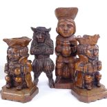 A pair of carved oak Toby figure candle stands, height 22cm, and 2 other wood carvings (4)