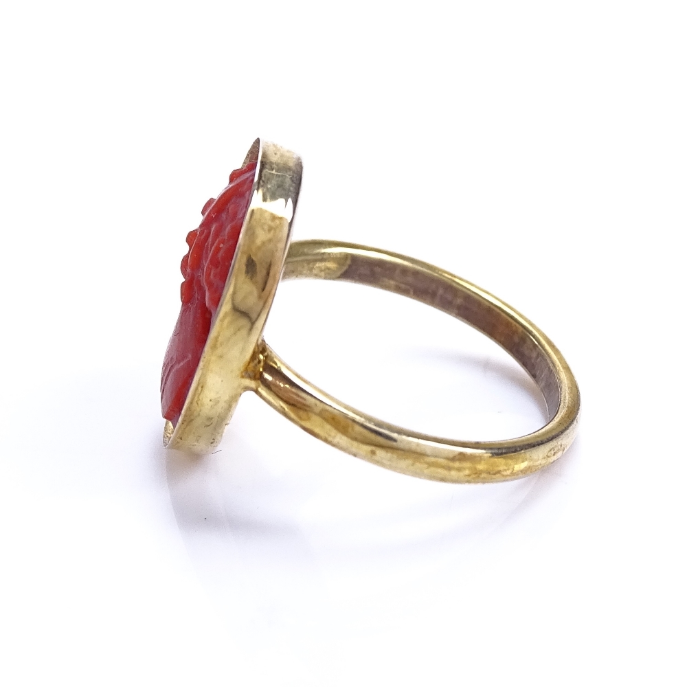 An unmarked silver-gilt relief carved coral cameo ring, setting height 16.7mm, size J, 2.5g Good - Image 3 of 5