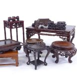 A group of Chinese carved hardwood stands, largest 30cm across