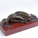 A 19th century patinated bronze sculpture, prostrate figure, unsigned, on rouge marble base, base