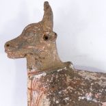 An Antiquity terracotta bull with traces of original paintwork, missing front legs, height approx