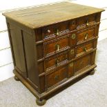 A 17th century joined oak chest of 4 long graduated drawers, with panelled drawer fronts, brass drop