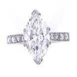 A 3.75ct marquise brilliant-cut solitaire diamond ring, graduated round brilliant-cut diamond