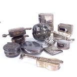 A group of silver pill and trinket boxes, designs include walnut, book, guitar, and envelope stamp