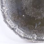 A large late Victorian silver salver, gadrooned rim with allover foliate engraved decoration, by