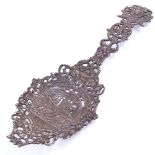 An elaborate Victorian silver serving spoon, allover pierced and relief cast Classical scene