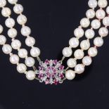 A triple-row cultured pearl ruby and diamond necklace, with pearls measuring approx 6.4mm, on an