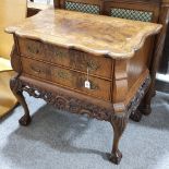 A Continental crossbanded walnut chest of 2 drawers, with shaped top, carved apron and cabriole