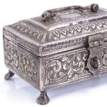 An early 20th century Indian silver jewel casket, allover relief embossed foliate decoration, raised