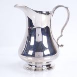 An Elizabeth II silver baluster cream jug with scrolled acanthus leaf handle, makers marks W Ltd,