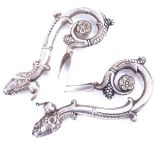 A pair of 19th century unmarked silver ram's-head design ornaments, length 11cm Both in good