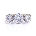 A modern 18ct gold 3-stone synthetic moissanite ring, largest diameter 6.34mm, size O, 4.6g Very