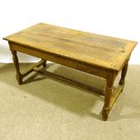 An 18th/19th century oak farmhouse refectory table, with plank top and stretcher base, 145cm x 72cm