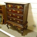 An 18th century oak chest on stand, with carved shaped pediment, 2 short shaped frieze drawers and