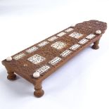A Chinese 19th century relief carved wood games board, with inset carved ivory panels, on turned