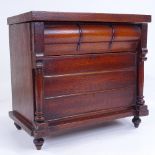 A small Victorian mahogany table-top cabinet in the form of a chest of drawers, with rising lid