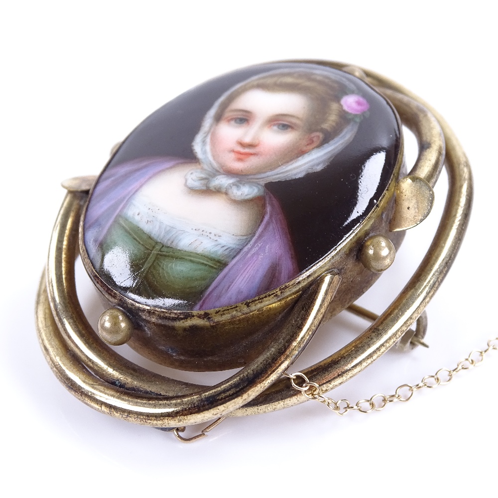 A 19th century miniature hand painted watercolour portrait on porcelain brooch, depicting a young - Image 2 of 5