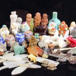 A collection of miniature Oriental porcelain figure perfume bottles, a carved amber netsuke in the