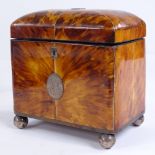 A 19th century tortoiseshell tea caddy, inlaid silver wirework and silver ball feet, with inner