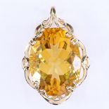 A modern 9ct gold oval citrine pendant, with openwork settings, pendant height 29.4mm, 5.4g Very