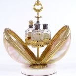 A 19th century mother-of-pearl shell box, containing 4 original cut-glass perfume bottles with