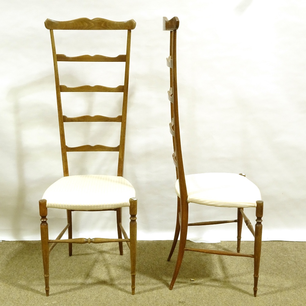 A pair of mid-century Italian Chiavari exaggerated high back chairs, with shaped ladder backs