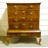 An 18th century crossbanded walnut chest on stand, with brass drop handles, width 93cm, height 122cm