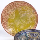A Spanish lustre glaze pottery bowl, with painted bird decoration, diameter 33cm, and another