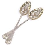 A pair of George III silver-gilt berry spoons, with polished and textured decoration and engraved